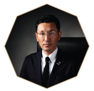 image of Takamine President Hayami Tahte wearing a black suit and black tie